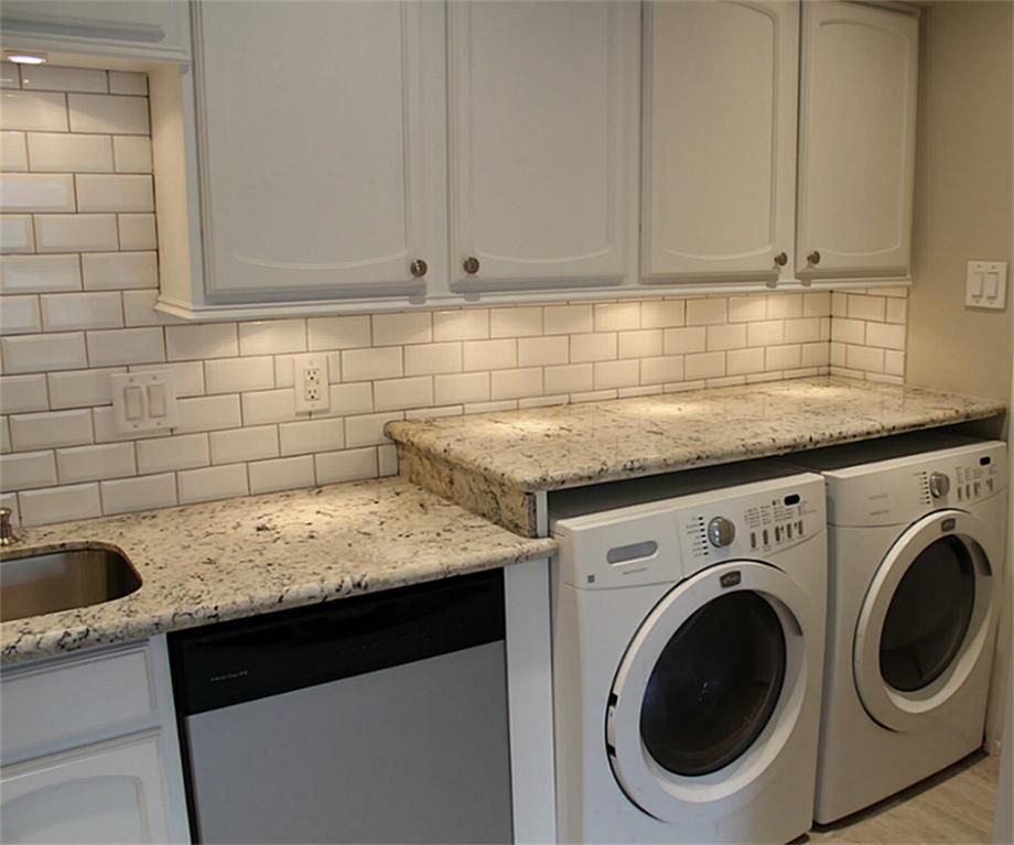 workspace with extended granite countertops over washer