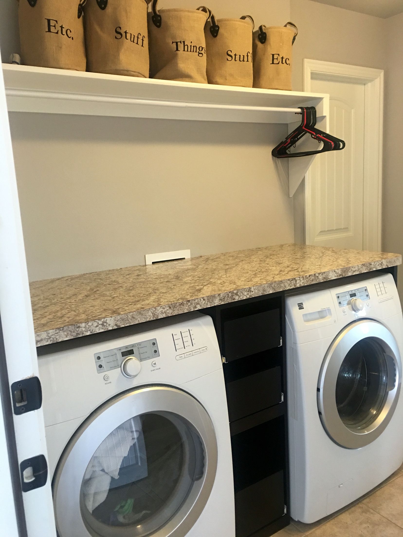 Laundry room with counter over the washer dryer, slide